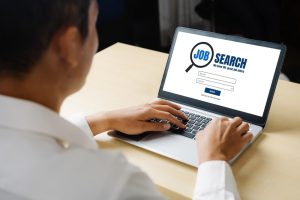 Men is browsing jobs on his laptop